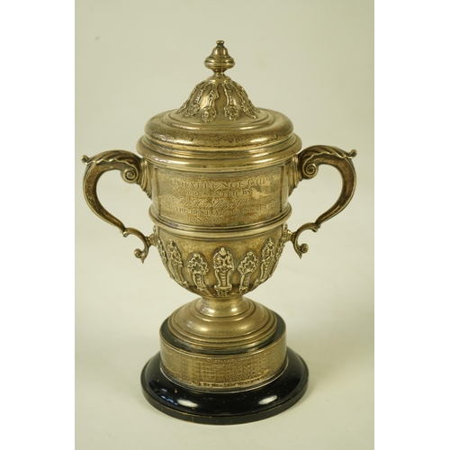 81 - A George V silver two handled presentation cup and cover, by Charles & Richard Comyns, with engraved... 