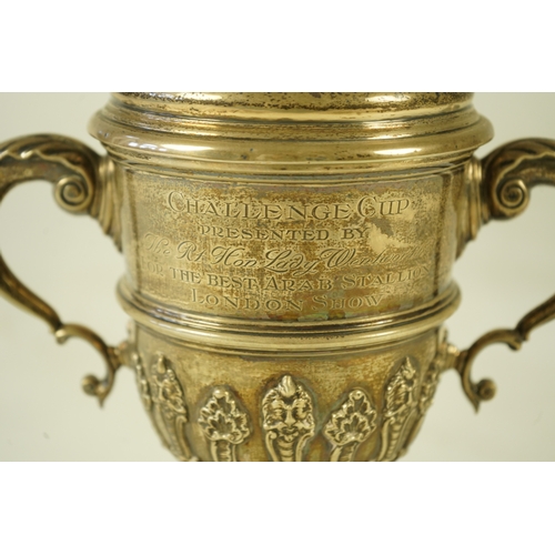 81 - A George V silver two handled presentation cup and cover, by Charles & Richard Comyns, with engraved... 