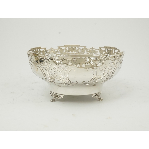 85 - An Elizabeth II pieced silver fruit bowl, by Walker & Hall, with scroll piercing, on three scroll an... 