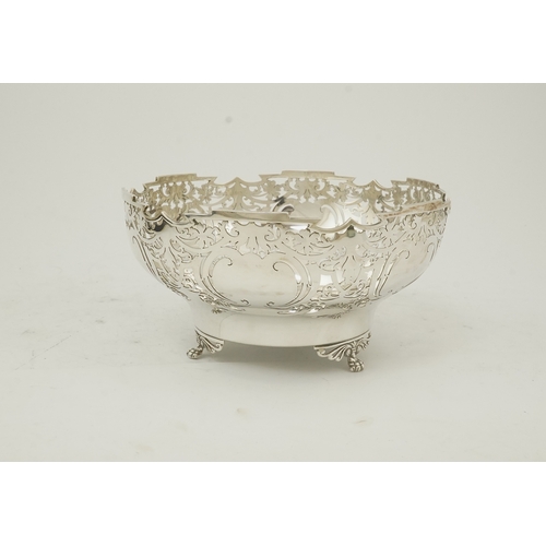 85 - An Elizabeth II pieced silver fruit bowl, by Walker & Hall, with scroll piercing, on three scroll an... 