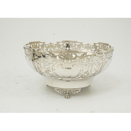 85 - An Elizabeth II pieced silver fruit bowl, by Walker & Hall, with scroll piercing, on three scroll an... 