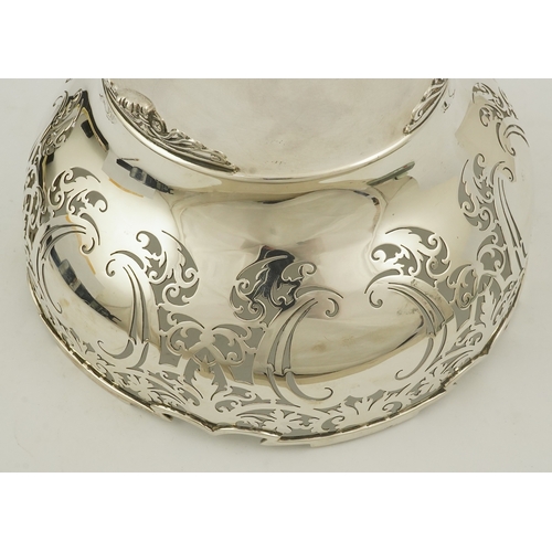 85 - An Elizabeth II pieced silver fruit bowl, by Walker & Hall, with scroll piercing, on three scroll an... 