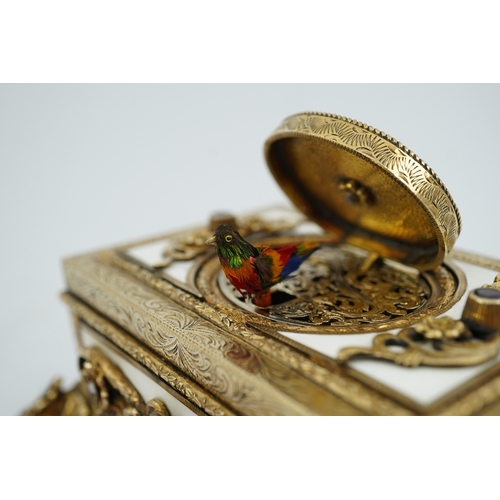 91 - A late Karl Griesbaum Model 17 silver gilt, white enamel, garnet and cultured pearl set automaton si... 