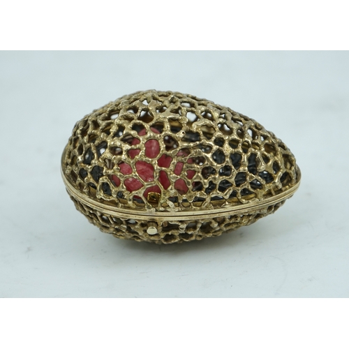 98 - An Elizabeth II pierced silver gilt surprise egg by Stuart Devlin, opening to reveal a nest with thr... 