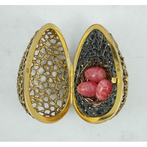 98 - An Elizabeth II pierced silver gilt surprise egg by Stuart Devlin, opening to reveal a nest with thr... 