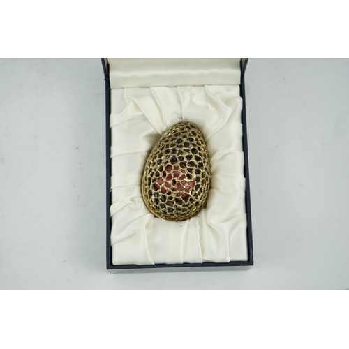 98 - An Elizabeth II pierced silver gilt surprise egg by Stuart Devlin, opening to reveal a nest with thr... 