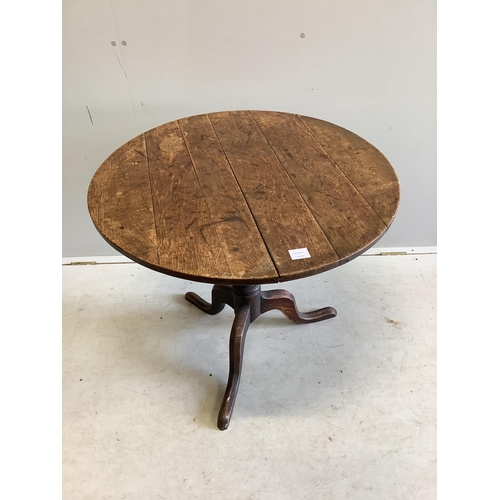 1007 - A George III circular oak tilt top tripod table, diameter 82cm, height 70cm. Condition - fair