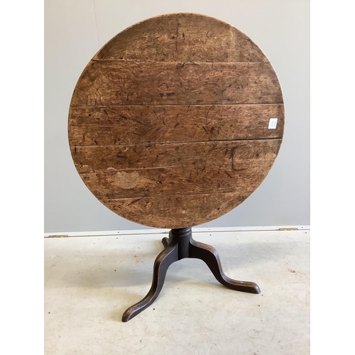 1007 - A George III circular oak tilt top tripod table, diameter 82cm, height 70cm. Condition - fair