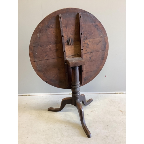 1007 - A George III circular oak tilt top tripod table, diameter 82cm, height 70cm. Condition - fair