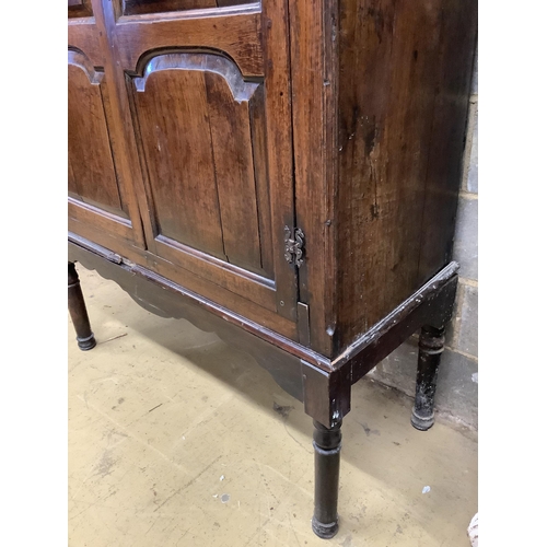 1009 - A mid 18th century carved oak cupboard, on associated stand, a.f., width 130cm, depth 55cm, height 1... 