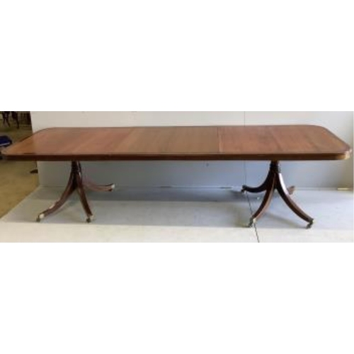 1021 - A reproduction mahogany twin pillar extending dining table, extended 300cm, two spare leaves, depth ... 