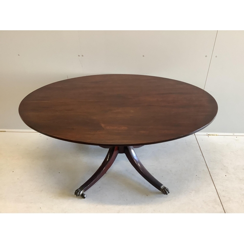 1058 - A George III mahogany oval pedestal dining table with brass claw feet, width 152cm, depth 105cm, hei... 