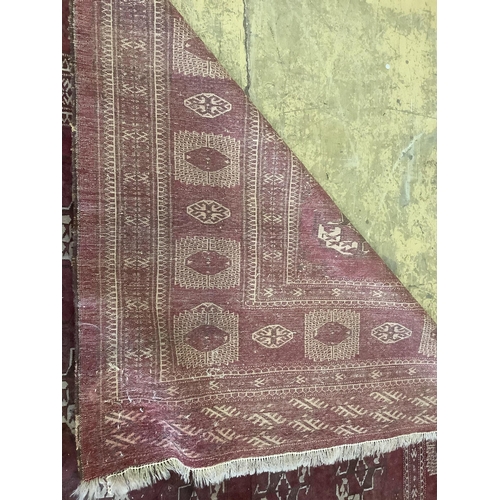 1115 - An antique Bokhara carpet, 384 x 286cm. Condition - fair