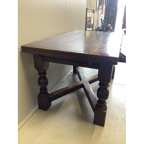 1128 - An 18th century style rectangular oak draw leaf refectory dining table, width 244cm extended, depth ... 