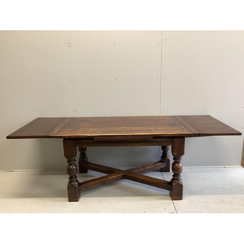 1128 - An 18th century style rectangular oak draw leaf refectory dining table, width 244cm extended, depth ... 