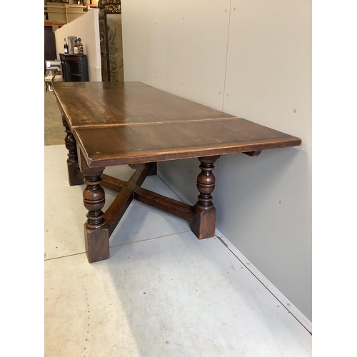 1128 - An 18th century style rectangular oak draw leaf refectory dining table, width 244cm extended, depth ... 