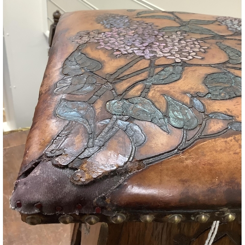 1137 - An early 20th century Liberty & Co. Arts & Crafts style stool with embossed leather seat, (later col... 