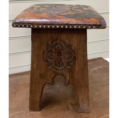 1137 - An early 20th century Liberty & Co. Arts & Crafts style stool with embossed leather seat, (later col... 