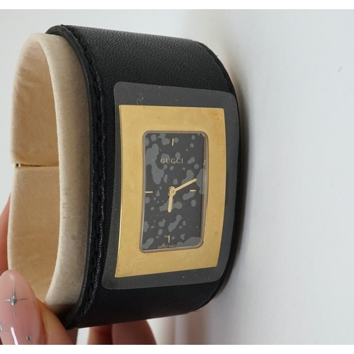 1284 - A lady's Gucci watch with wide leather strap, with box and papers.