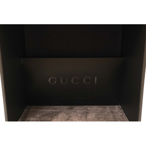 1284 - A lady's Gucci watch with wide leather strap, with box and papers.