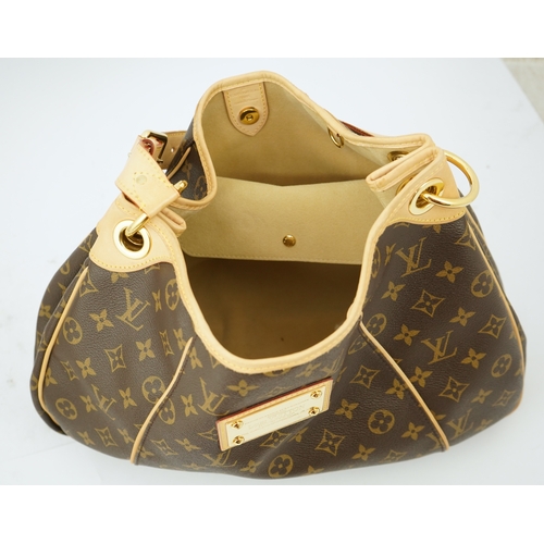 1305 - A Louis Vuitton brown monogram canvas with natural cowhide trim and gold-toned hardware, with origin... 