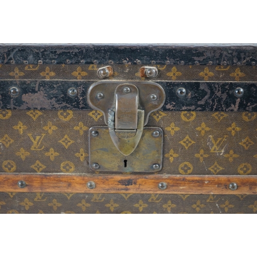 1321 - A vintage Louis Vuitton trunk, with wooden slats and black painted steel bound LV canvas, label for ... 