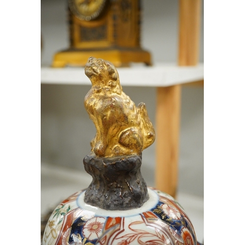 1382 - An 18th/19th century Japanese Imari vase with lion finial cover, 52cm high. Condition - Cover restor... 