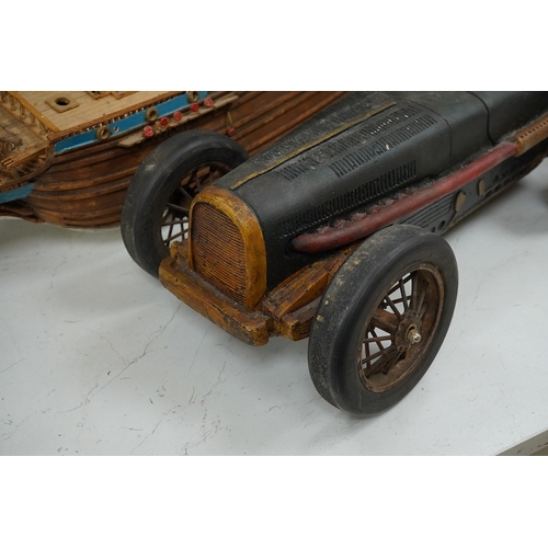 1391 - A scratch built model of a ship and a toy racing car and driver, ship 89cm wide. Condition - poor... 