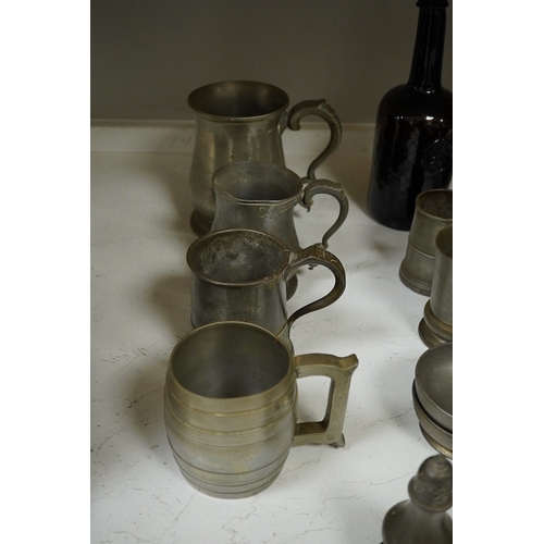 1397 - A collection of 18th and 19th century pewter mugs and other items including a 19th century wine bott... 