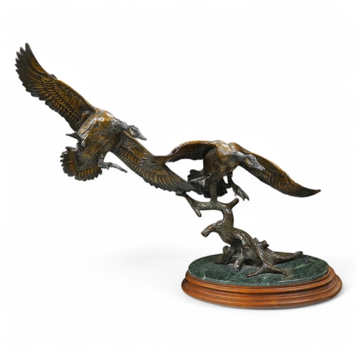 1398 - A modern large cast bronze sculpture of two flying geese, on an oval plinth, 90cm wide. Condition - ... 