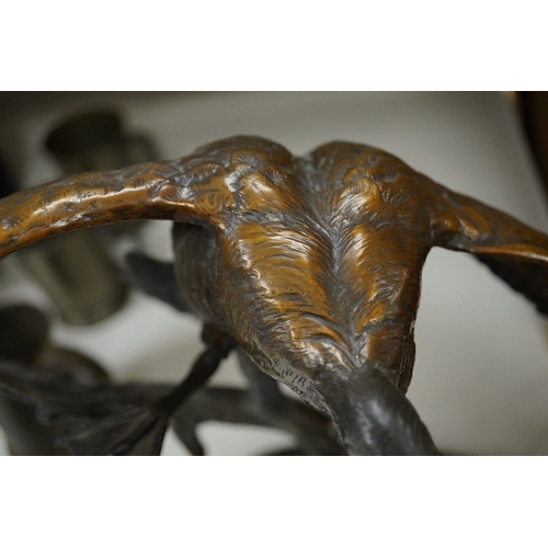 1398 - A modern large cast bronze sculpture of two flying geese, on an oval plinth, 90cm wide. Condition - ... 