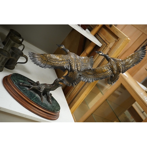 1398 - A modern large cast bronze sculpture of two flying geese, on an oval plinth, 90cm wide. Condition - ... 