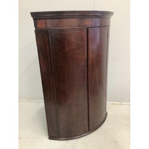 35 - A George III inlaid mahogany bow front hanging corner cupboard, width 74cm, depth 50cm, height 107cm... 