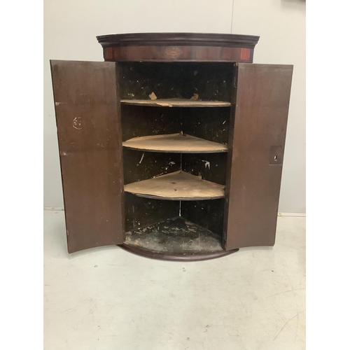 35 - A George III inlaid mahogany bow front hanging corner cupboard, width 74cm, depth 50cm, height 107cm... 