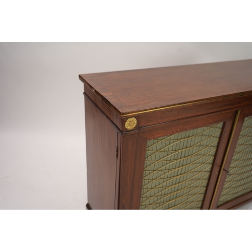 1141 - A Regency ormolu mounted rosewood and mahogany side cabinet, with brass front top and two silk pleat... 