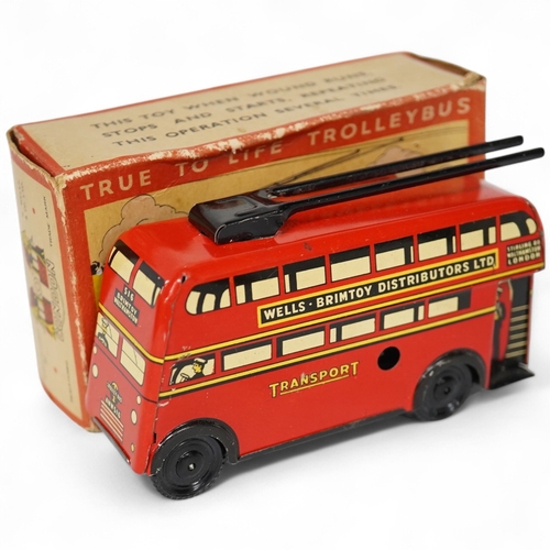 379 - A boxed Wells Brimtoy tinplate clockwork trolley bus loosely in London Transport livery, together wi... 