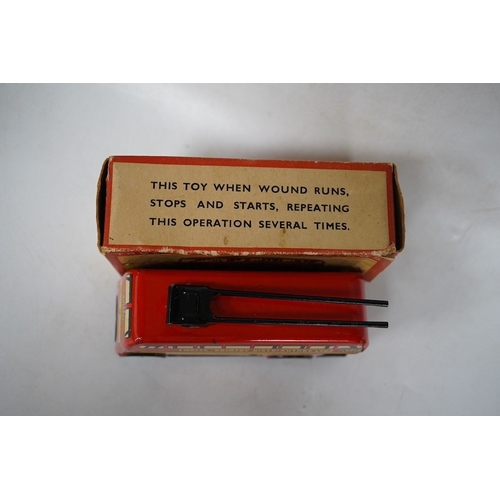 379 - A boxed Wells Brimtoy tinplate clockwork trolley bus loosely in London Transport livery, together wi... 