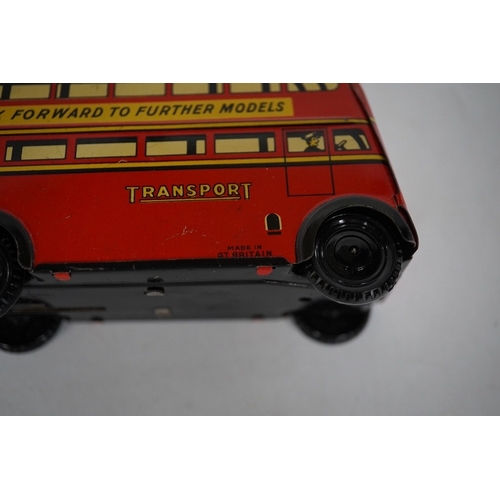 379 - A boxed Wells Brimtoy tinplate clockwork trolley bus loosely in London Transport livery, together wi... 