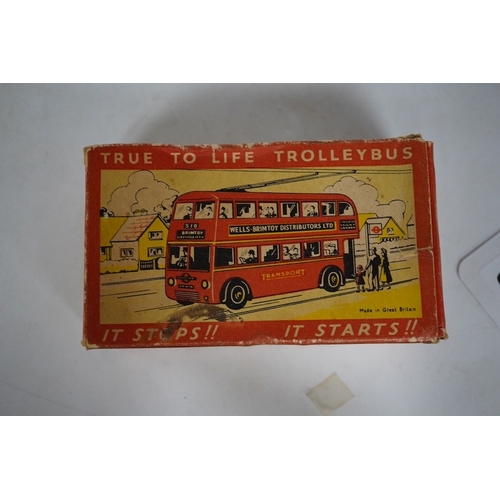 379 - A boxed Wells Brimtoy tinplate clockwork trolley bus loosely in London Transport livery, together wi... 