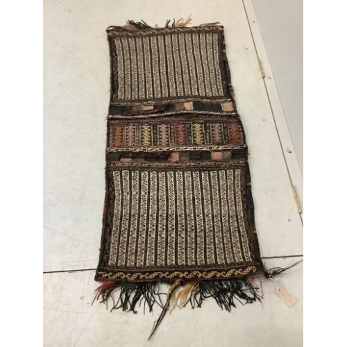 108 - An Afghan flatweave salt bag, a double saddle bag and one other bag, largest approximately 120 x 80c... 