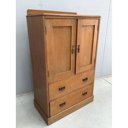 114 - An early 20th century small oak press cupboard, width 75cm, depth 42cm, height 124cm