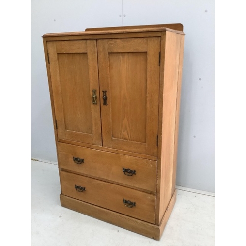 114 - An early 20th century small oak press cupboard, width 75cm, depth 42cm, height 124cm