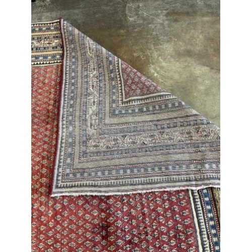 141 - A red ground Araak carpet, 330 x 240