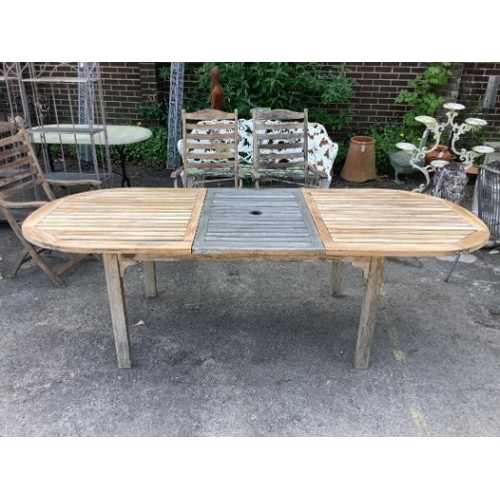 28 - A weathered slatted teak Nova extending garden table, width 240cm extended, depth 100cm, height 71cm... 