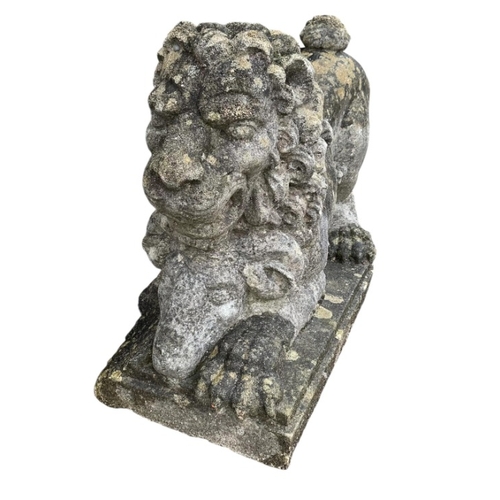 67 - A reconstituted stone recumbent lion and ram garden ornament, length 60cm, together with a painted c... 