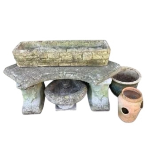68 - A curved reconstituted stone garden bench, length 102cm, together with three planters and a bird bat... 