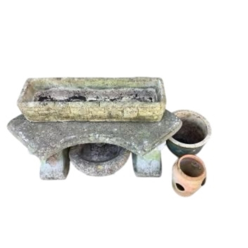 68 - A curved reconstituted stone garden bench, length 102cm, together with three planters and a bird bat... 