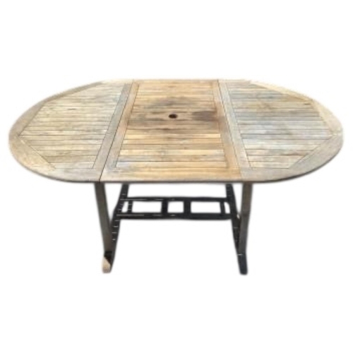 75 - Six Sherwood teak elbow chairs, a weathered teak oval extending garden table, 181cm extended, depth ... 