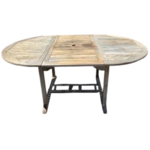 75 - Six Sherwood teak elbow chairs, a weathered teak oval extending garden table, 181cm extended, depth ... 