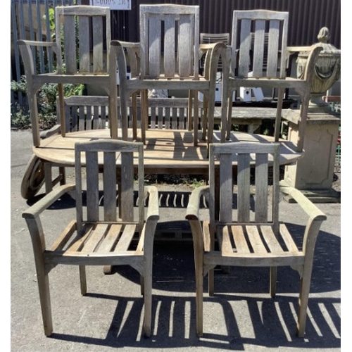 75 - Six Sherwood teak elbow chairs, a weathered teak oval extending garden table, 181cm extended, depth ... 